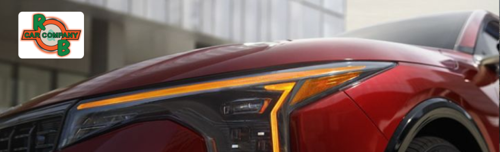 Used Kia Forte and Kia Sportage vehicles lined up at R&B Car Company, Fort Wayne